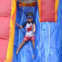 Summer Fun boy going down a slide
